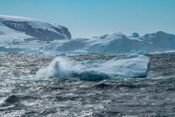 Rough-sea waves crash against an iceberg, creating a splash and spray, Weddell Sea, Antarctic Peninsula, Antarctica