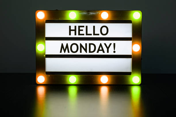 istock Lightbox with yellow and orange lights in dark room with words - Hello Monday! 1316104157