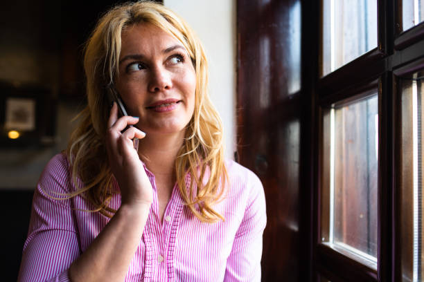 istock A beautiful woman smiling while talking on the phone 1316104491