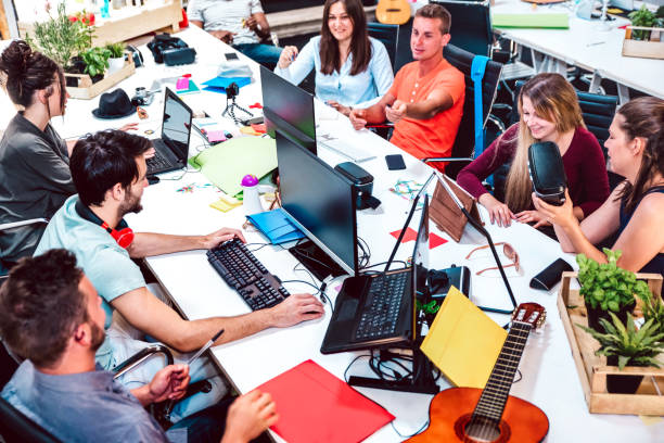 Young people employee workers on computer at urban alternative studio - Human resources and business concept in co working space - Start up entrepreneurs inside modern office - Bright contrast filter