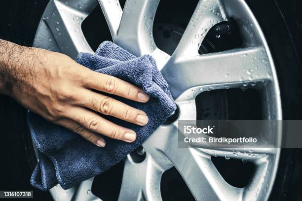 Hand Is Wipe The Alloy Wheel With A Microfiber Cloth Stock Photo - Download Image Now