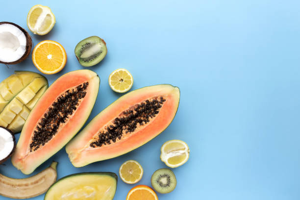 istock Different fresh tropical cut fruits on a blue background 1316107720