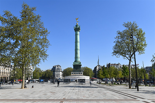 Paris, France-04 27 2021:The Place de la Bastille is a square where the Bastille prison stood until the storming of the French Revolution.No vestige of the prison remains.The July Column stands at the center of the square.