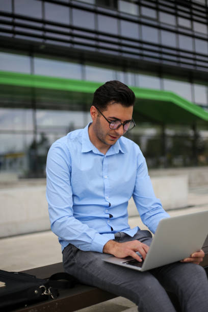 istock Business man using laptop while sitting on the bench. stock photo 1316112561