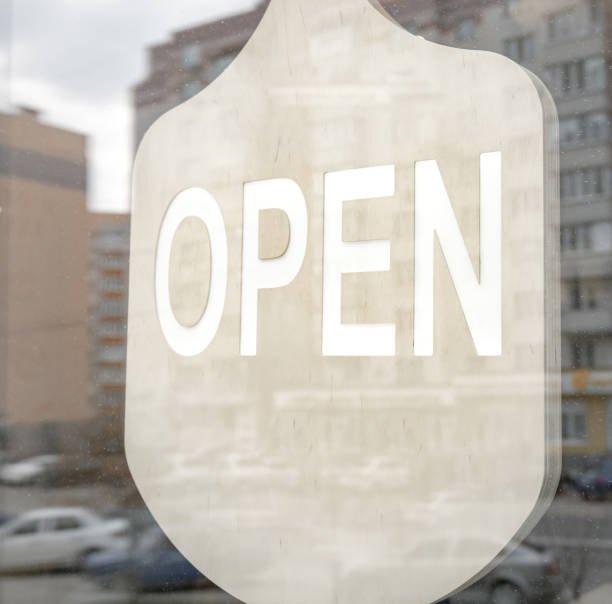 istock Close up inscription open on glass doors. 1316112988