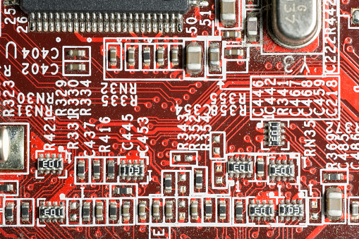 Closeup macro shot of elements of a red motherboard