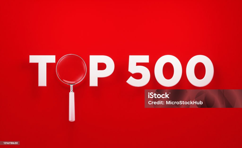 Top 500 Concept - Magnifier Sitting Amid The White Top 500 Word On Red Background Magnifier sitting amid the top 500 word on red background. Horizontal composition with copy space. Directly above. Top 500 concept. Number 500 Stock Photo