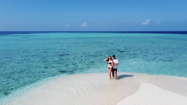istock Mature couple on vacation hugging on a tropical beach 1316120525