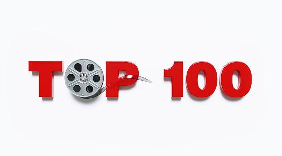 Film reel sitting amid the top 100 word on white background. Horizontal composition with clipping path and copy space. Directly above. Top 100 concept.