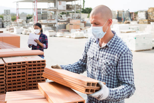 istock Male worker in face mask stacks thermal insulation panels 1316121268
