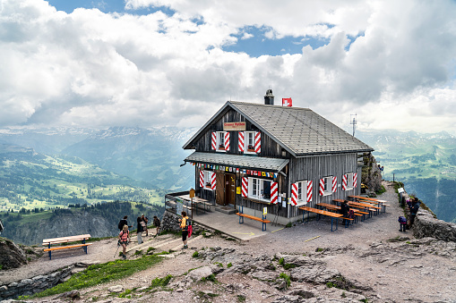Grosser Mythen, Canton of Schwyz, Switzerland - May 20, 2020 : on the summit of the 'grosser Mythen', above Schwyz. Hikers take a break and refreshments in the restaurant.