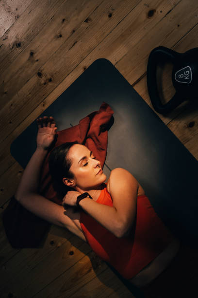 istock Young Fit Woman Laying on a Gray Exercise Mat After a Good Workout 1316128876