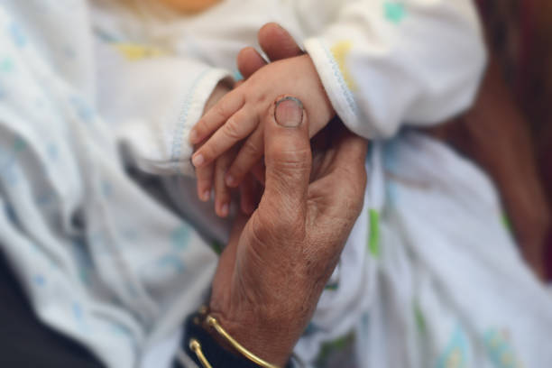 istock old man holding child's hands. selective focus 1316132567