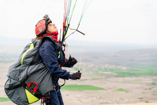istock female Paraglider over mountains 1316133365