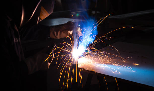 istock A man welder with construction gloves and a welding mask is welded with a welding machine metal in workshop. 1316134504