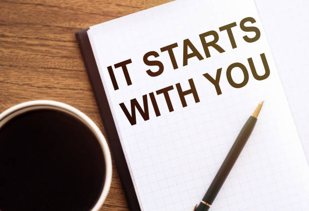 istock IT STARTS WITH YOU - text on notepad on wooden desk. 1316134662