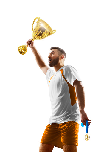 Soccer winner isolated. Soccer player holds a cup in his hands. The winner of the soccer cup. Vertical