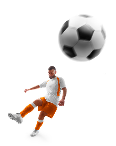 Professional soccer. Player kicks the ball on the soccer field. Isolated. Sport