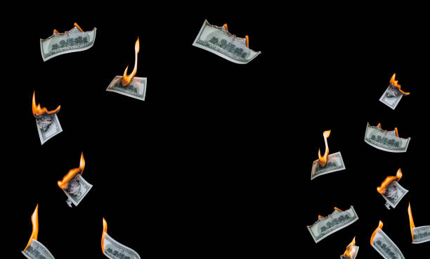 istock Several 100 dollar bills, falling down, burn on a black background. The concept of bankruptcy, depreciation, devaluation, wastefulness and waste of money. Copy space, isolated. 1316136565