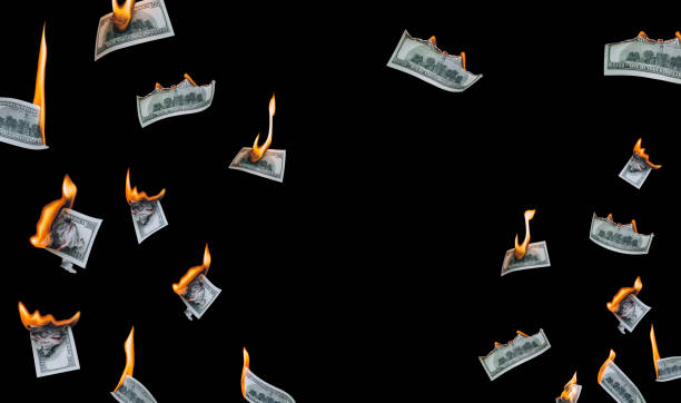 istock Several 100 dollar bills, falling down, burn on a black background. The concept of bankruptcy, default, depreciation, devaluation and wastefulness, waste of money. Copy space, isolated. 1316136569