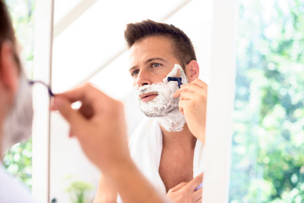 istock Handsome man shaving his face in the bathroom 1316137007