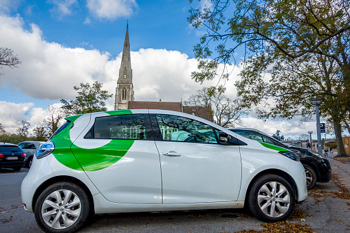 Copenhagen, Denmark - Oct 19, 2018: Small environmentally friendly electric car parked at a car parking area along Churchillparken Street.