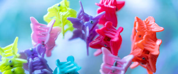 closeup of rainbow hair clips macro image of rainbow colored butterfly-shaped hair clips hair clip stock pictures, royalty-free photos & images