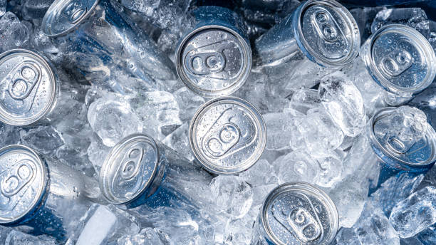 cold cans on ice inside a cooler cold aluminum cans surrounded by ice inside of a cooler cool box stock pictures, royalty-free photos & images