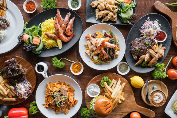 Table top view of spicy food. Top looking down at restaurant food spread on table. crockery stock pictures, royalty-free photos & images