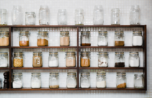 The view of different types of spices in glass containers.
