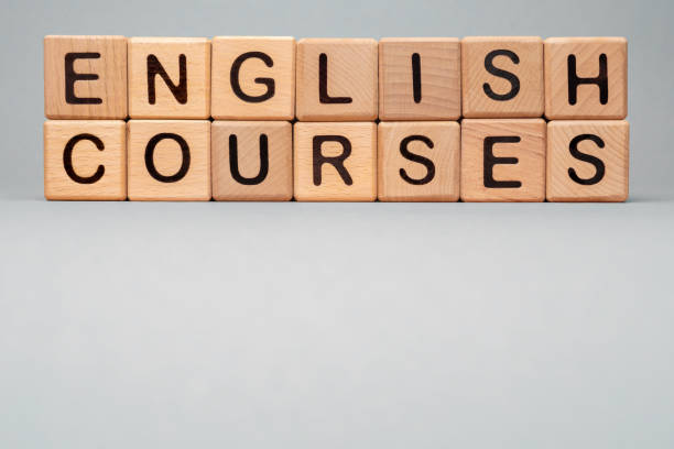 istock Language Courses English online learn icon cube. Wooden block toy cubes concept learning English Courses training. Speak English Courses icon words block wooden cubes concept foreign language tutoring 1316147153