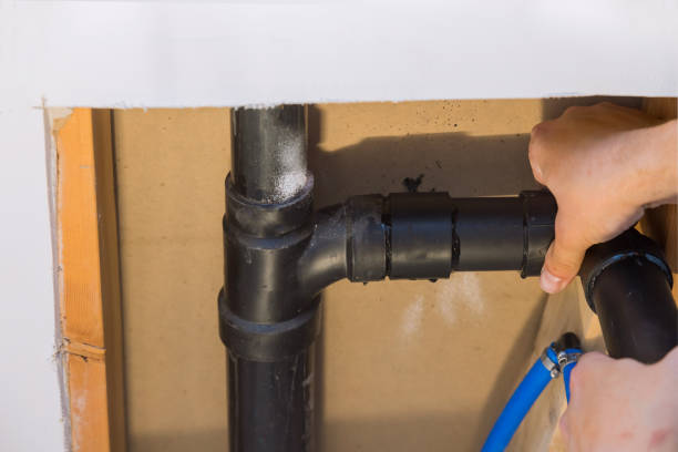 istock Plumber joining PVC sewage drain pipes on a home under construction 1316154794