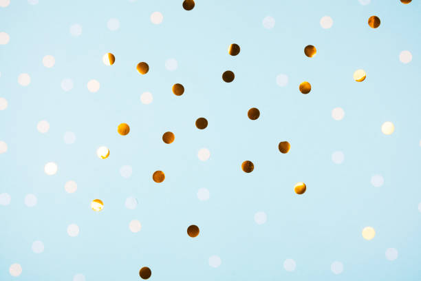 istock Festive light blue background with golden confetti 1316155004