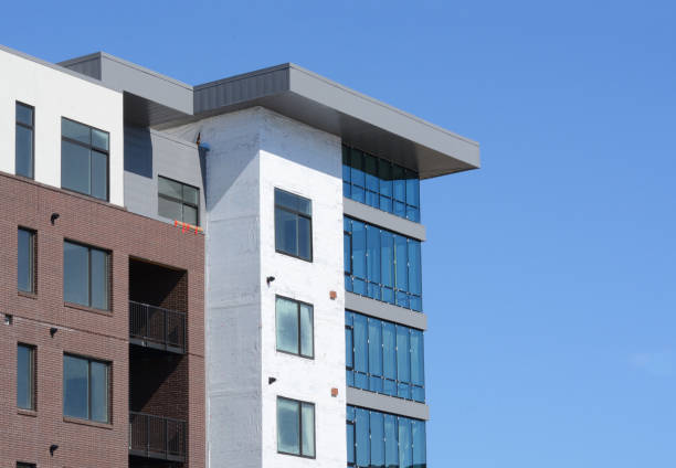 istock Construction of new building with windows and wrap still on exterior 1316157141