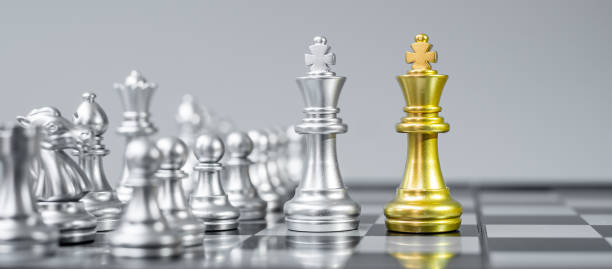 istock Gold and silver Chess King fgure on Chessboard against opponent or enemy. Strategy, Conflict, management, business planning, tactic, politic, communication and leader concept 1316160834
