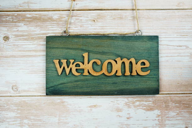 istock Welcome sign hanging on wooden background 1316166643