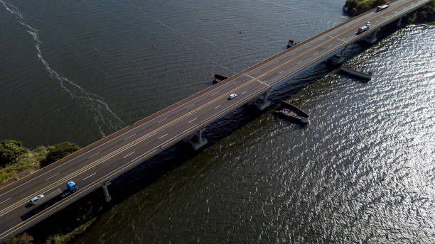 istock Large bridge crossing wide river 1316166753