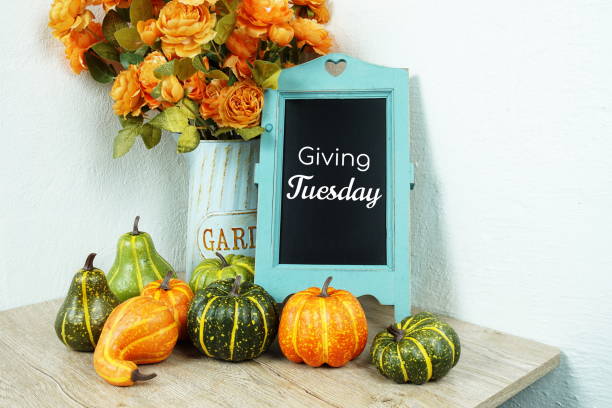 istock Giving Tuesday typography text with pumpkin decoration on wooden table 1316167703