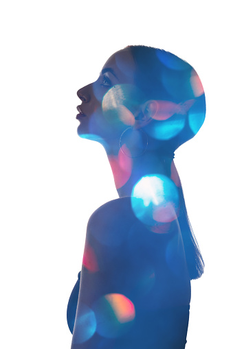 Double exposure silhouette. Female dream. Fantasy inner world. Colorful bokeh light in blue contrast shape profile portrait of pensive curious woman looking up isolated on white background.