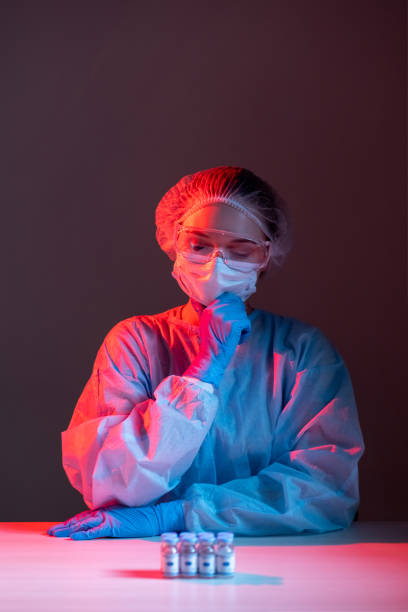 istock vaccine risk covid-19 pensive scientist dose vials 1316169843