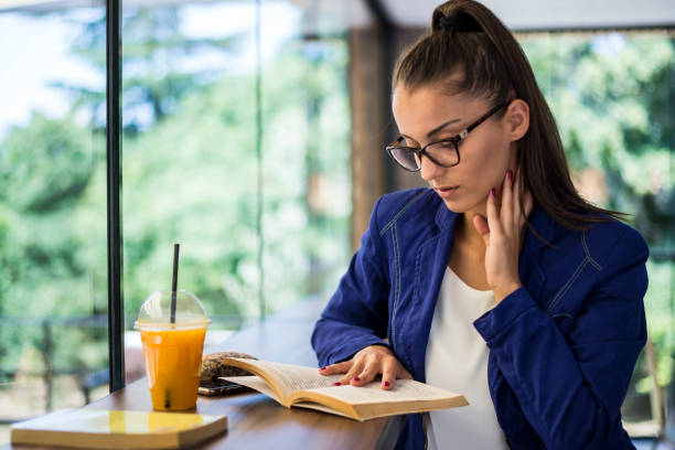 istock A woman is reading a book in a cafe. 1316170651
