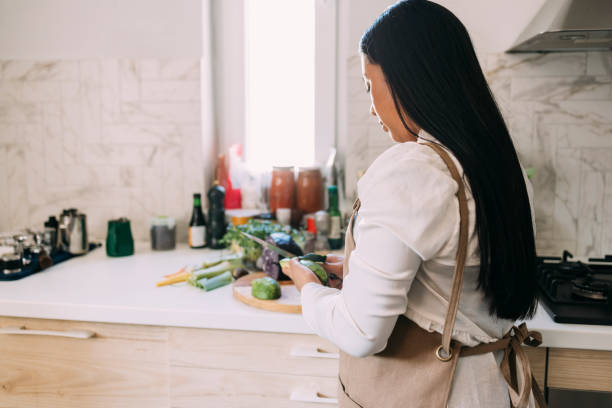 istock Anonymous Asian Woman Preparing a Tasty Meal in her Kitchen 1316172800