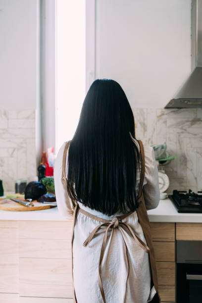 istock Young Unrecognizable Woman Preparing a Tasty Meal in her Kitchen 1316172819