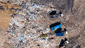 High angle shot of garbage trucks at a landfill