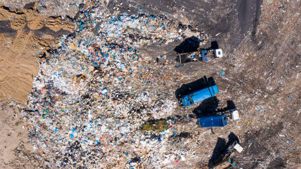 high angle shot of garbage trucks at a landfill - stack damaged imagens e fotografias de stock
