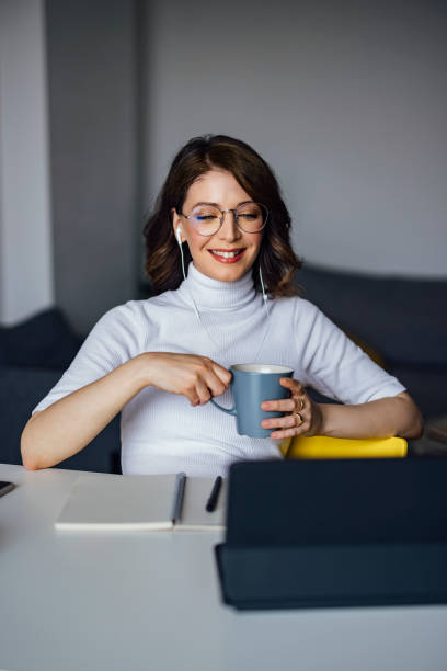 istock Smiling female entrepreneur holding coffee cup 1316173020
