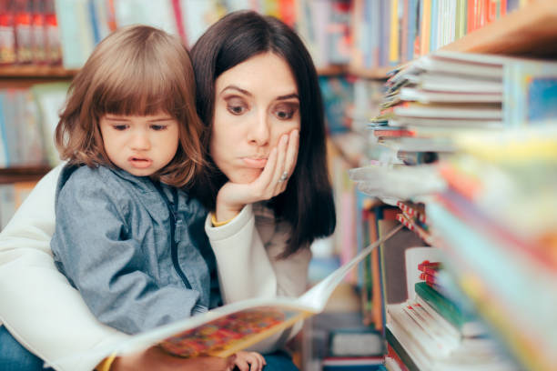 istock Stressed Mom Checking an Awkward Book for Kids in a Library 1316173501
