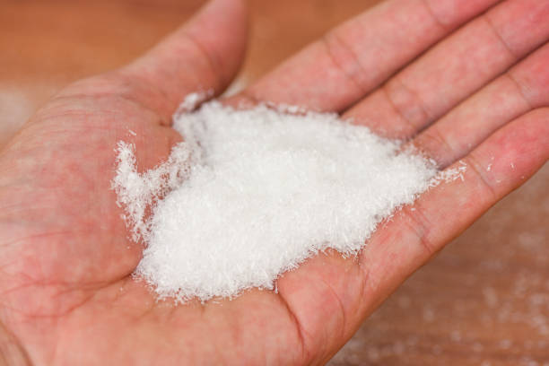 istock Monosodium glutamate on hand, MSG for food seasoning 1316174827