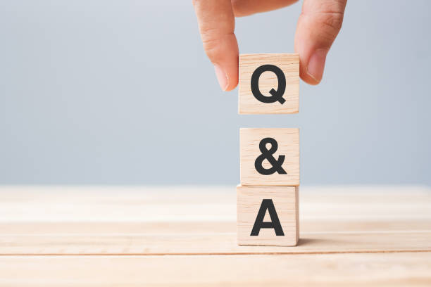 istock Hand holding Q and A word with wooden cube block. FAQ( frequency asked questions), Answer, Question  Ask, Information, Communication and Brainstorming Concepts 1316179241