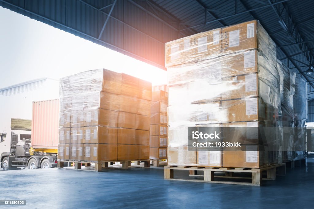 Stacked of Package Boxes Loading into Container Truck. Truck Parked Loading at Dock Warehouse. Delivery Service. Shipping Warehouse Logistics. Shipment Freight Truck Transportation. Freight Transportation Stock Photo